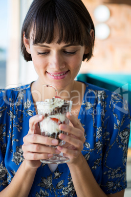 Woman holding a glass of dessert