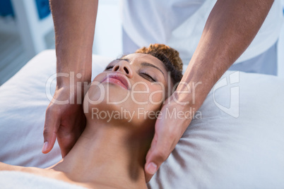 Woman receiving neck massage from physiotherapist