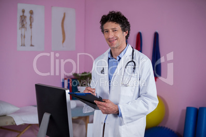 Portrait of physiotherapist holding clipboard