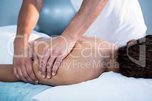 Physiotherapist giving hand massage to a woman