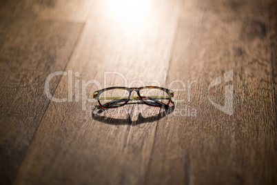 Spectacles on wooden table