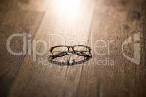 Spectacles on wooden table