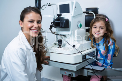 Female optometrist interacting with young patient