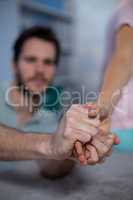 Physiotherapist massaging hand of a female patient