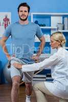 Physiotherapist assisting patient while exercising