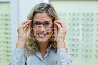 Smiling female customer trying spectacles