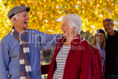 Happy senior couple at park during autumn