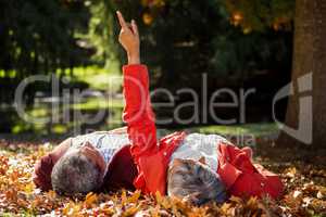 Couple resting on autumn leaves