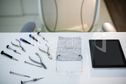 Work tools with spectacles and digital tablet on table