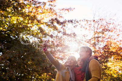 Family taking selfie against trees