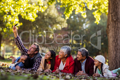 Man with family taking selfie at park