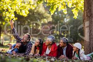 Man with family taking selfie at park