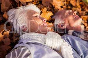 Senior couple sleeping on the ground