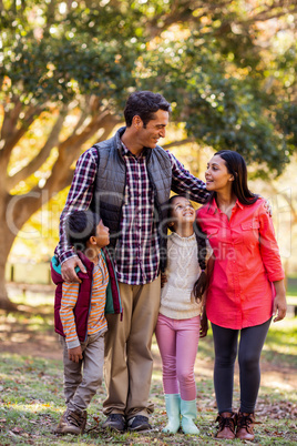 Front view of smiling family standing at park