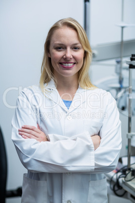 Female optometrist standing in ophthalmology clinic