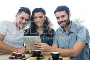 Three friends using a digital tablet