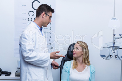 Optometrist interacting with female patient