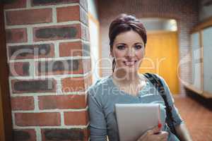 Portrait of mature student holding digital tablet