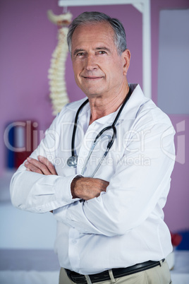 Portrait of physiotherapist standing with arms crossed