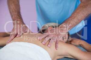 Woman receiving back massage from physiotherapist