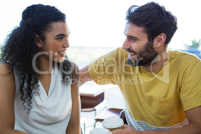 Couple talking to each other in coffee shop