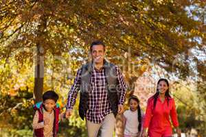 Family walking at park during autumn