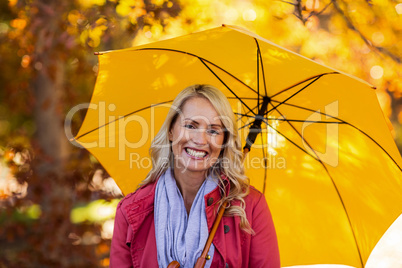 Woman holding umbrella at park