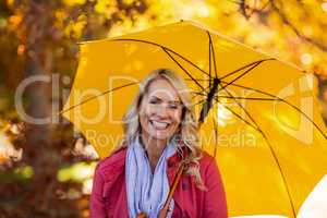 Woman holding umbrella at park