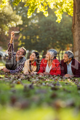 Man with family taking selfie at park