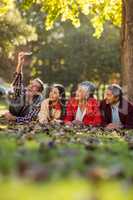 Man with family taking selfie at park