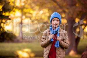 Portrait of boy holding scarf at aprk