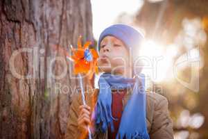Cute boy blowing pinwheel