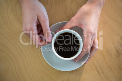 Hands holding a coffee cup