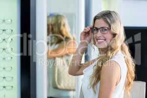 Beautiful female customer trying spectacles
