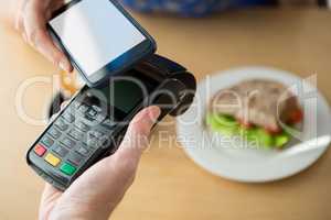 Hand making a payment through NFC technology