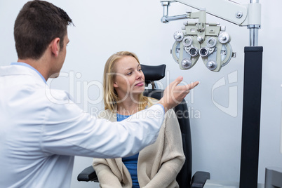 Optometrist interacting with female patient