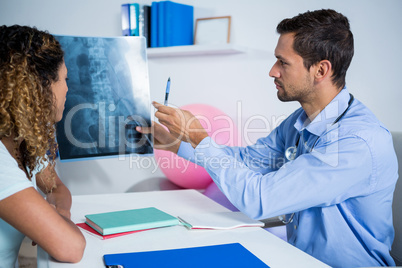 Physiotherapist explaining x-ray to patient