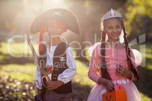 Portrait of happy siblings wearing costumes