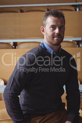 Mature student sitting on desk