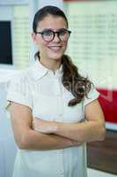 Smiling woman standing with arms crossed