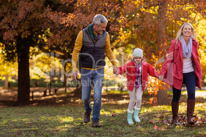 Family walking at park during autumn