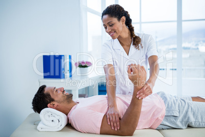 Physiotherapist giving hand massage to a patient