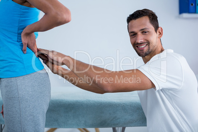 Physiotherapist examining womans back