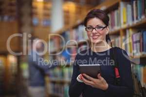 Portrait of mature student holding digital tablet