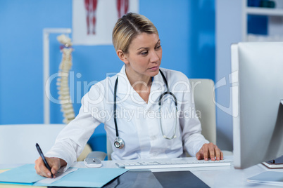 Physiotherapist writing a medical report