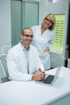 Smiling optometrists in ophthalmology clinic