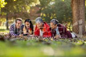 Family using mobile phone at park