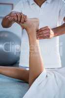 Woman receiving foot massage from physiotherapist