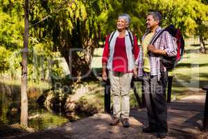 A senior couple walking with their equipment