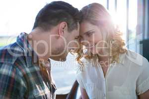 Couple looking face to face in cafeteria